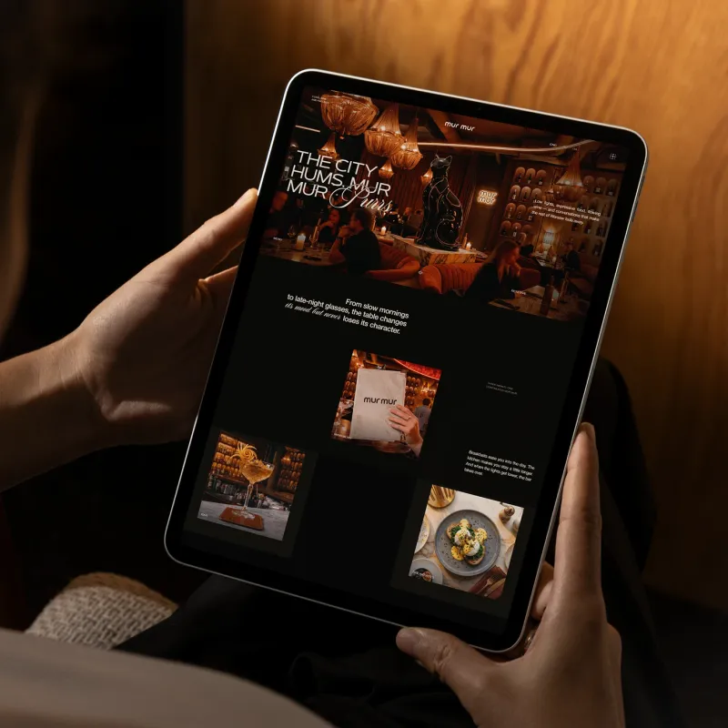 mur mur restaurant landing page on a tablet: the first screen with the cat statue and the menu section
