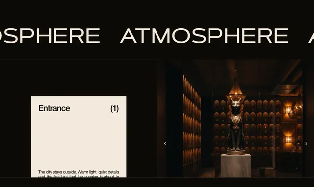 “Atmosphere” slider: the restaurant entrance with the signature cat statue